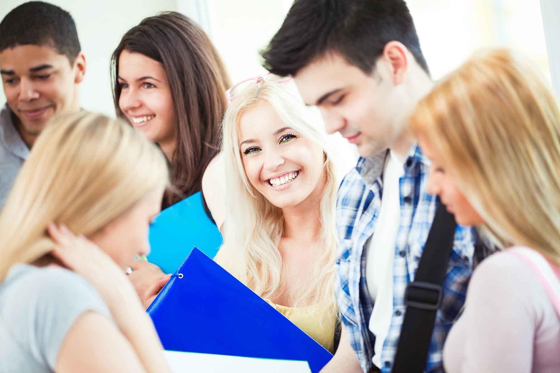 Young, smiling students standing in group